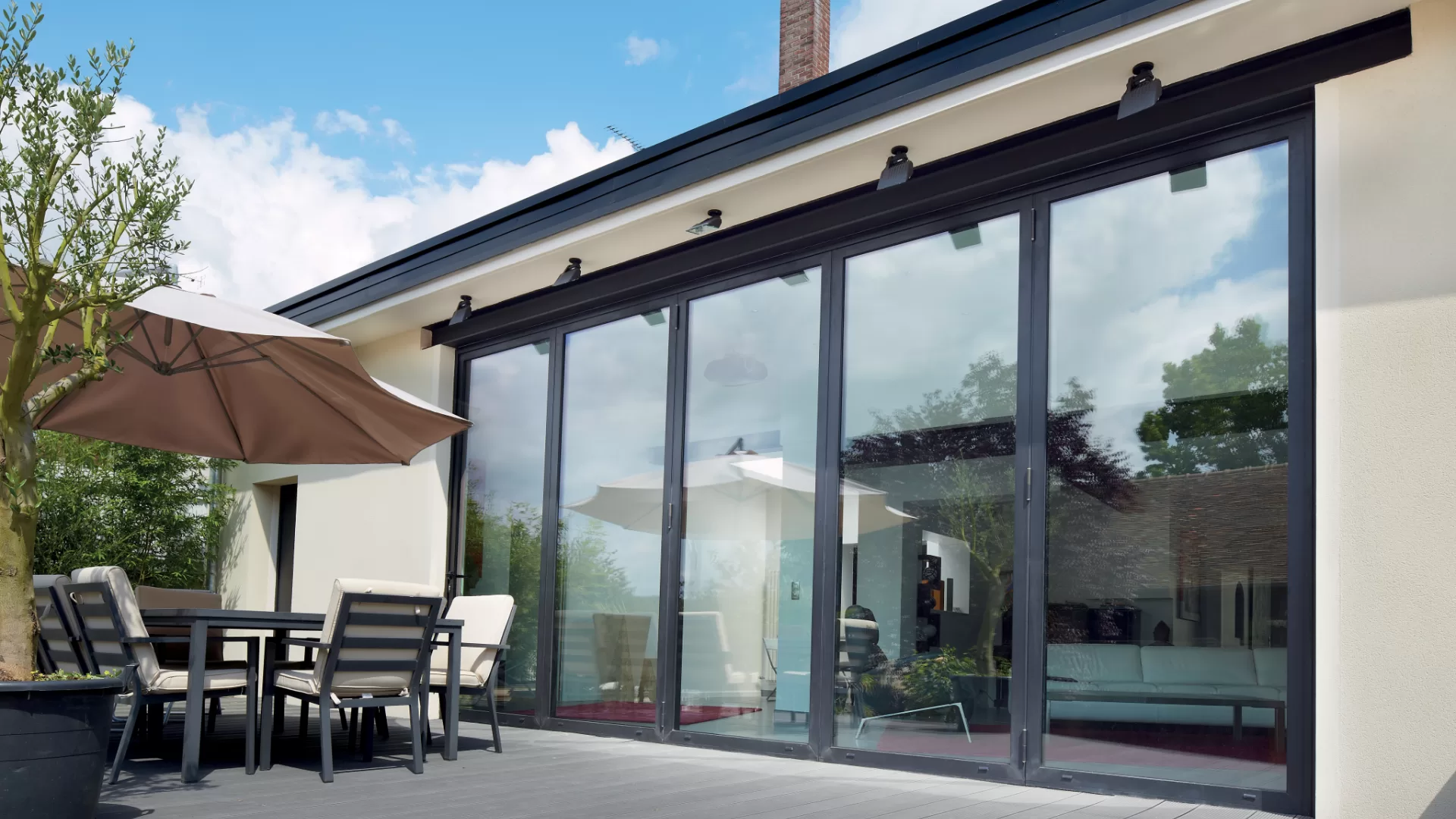 Open-plan living room with aluminium bifold doors onto the garden